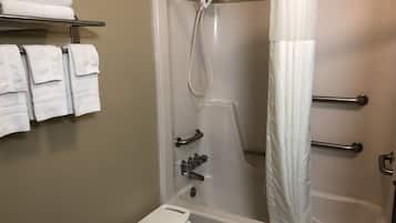 A shower area with a white shower curtain, a handheld showerhead, and a small white step stool.