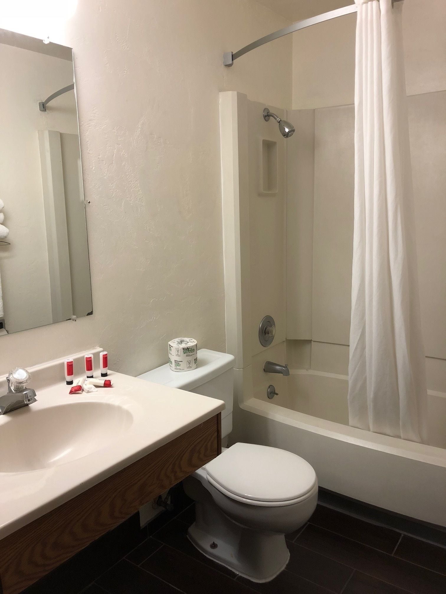 A bathroom with a white sink, toilet, and bathtub.
