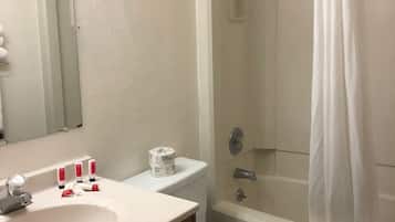 A bathroom with a white sink, toilet, and bathtub.