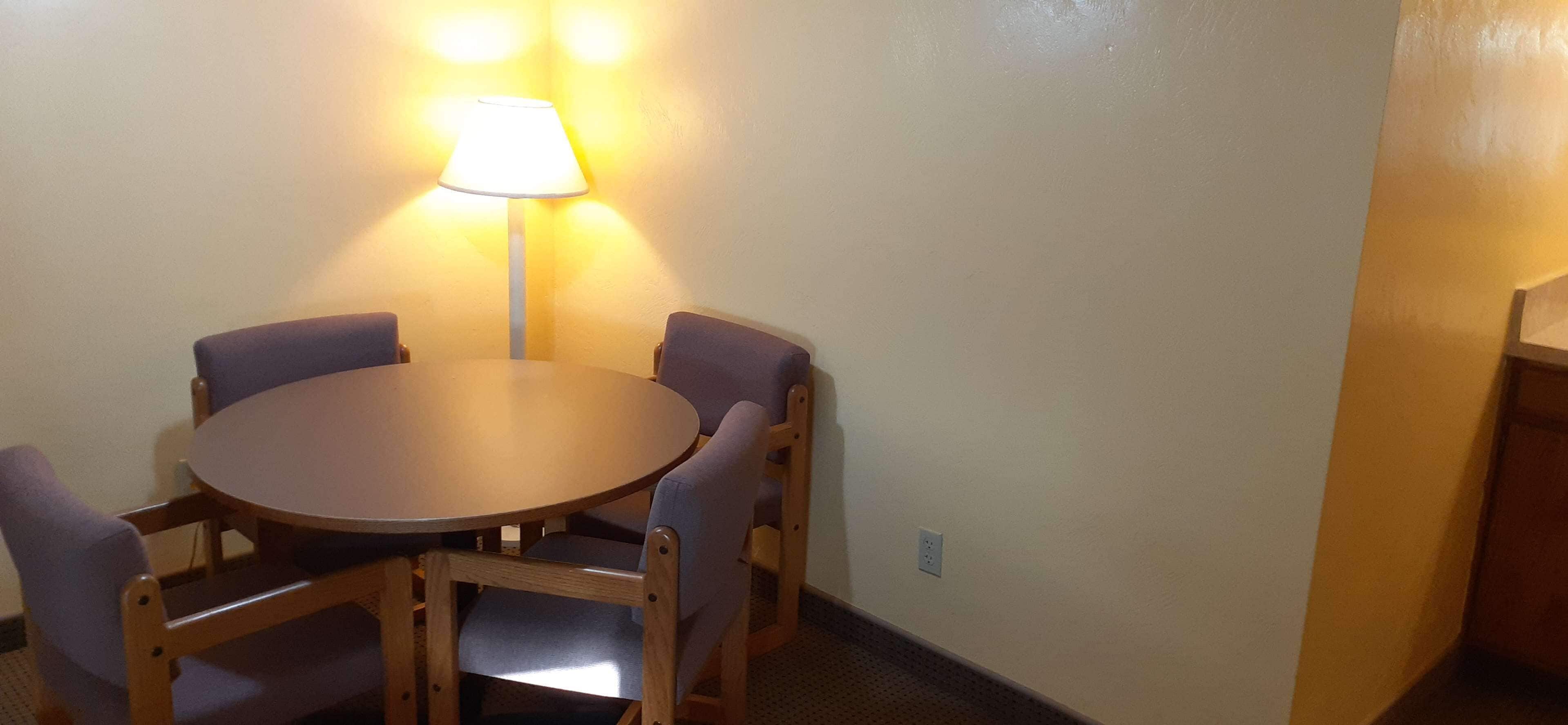 A small dining area with a round table and four chairs.