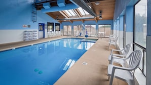 An indoor swimming pool with clear blue water, surrounded by white plastic chairs and a sunroofed ceiling. - SureStay Hotel by Best Western Ellensburg (Ellensburg)