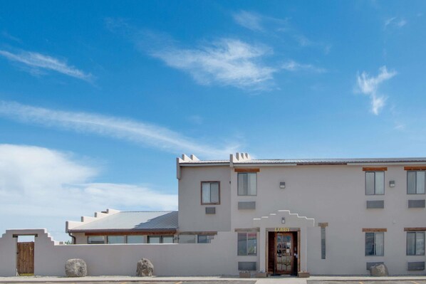 Stylish two-story building with a flat roof and glass door entrance.