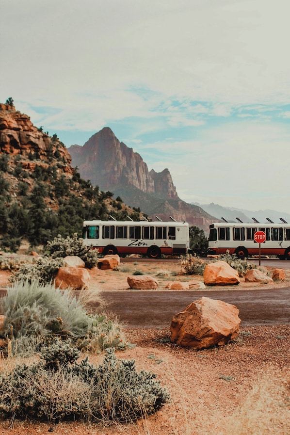A bus parked on a dirt road with a stop sign in the foreground. - Red Roof Inn St George, UT - Convention Center (St. George)