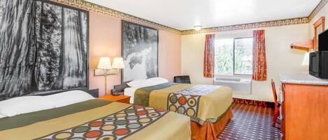 A hotel room with two beds, a desk, a chair, a television, and a window with curtains.