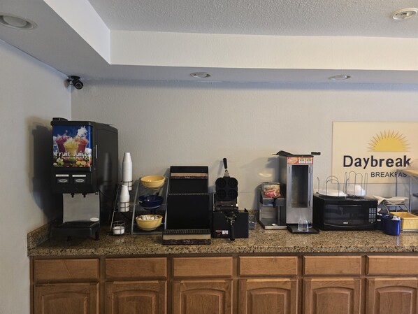Enjoy a convenient breakfast at the breakfast bar with a waffle maker, coffee machine, and microwave.