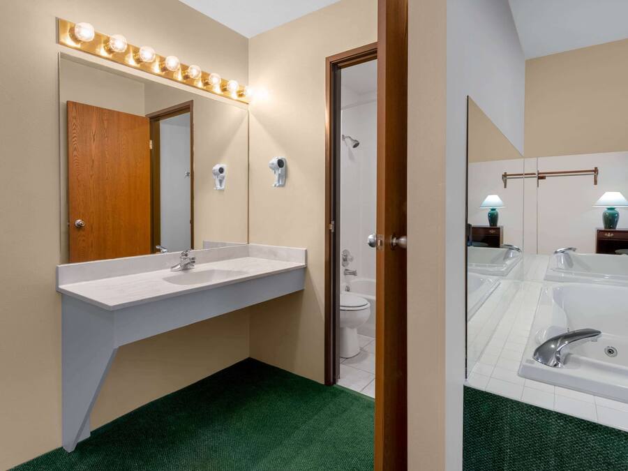 A bathroom with a vanity, a shower, and a bathtub.