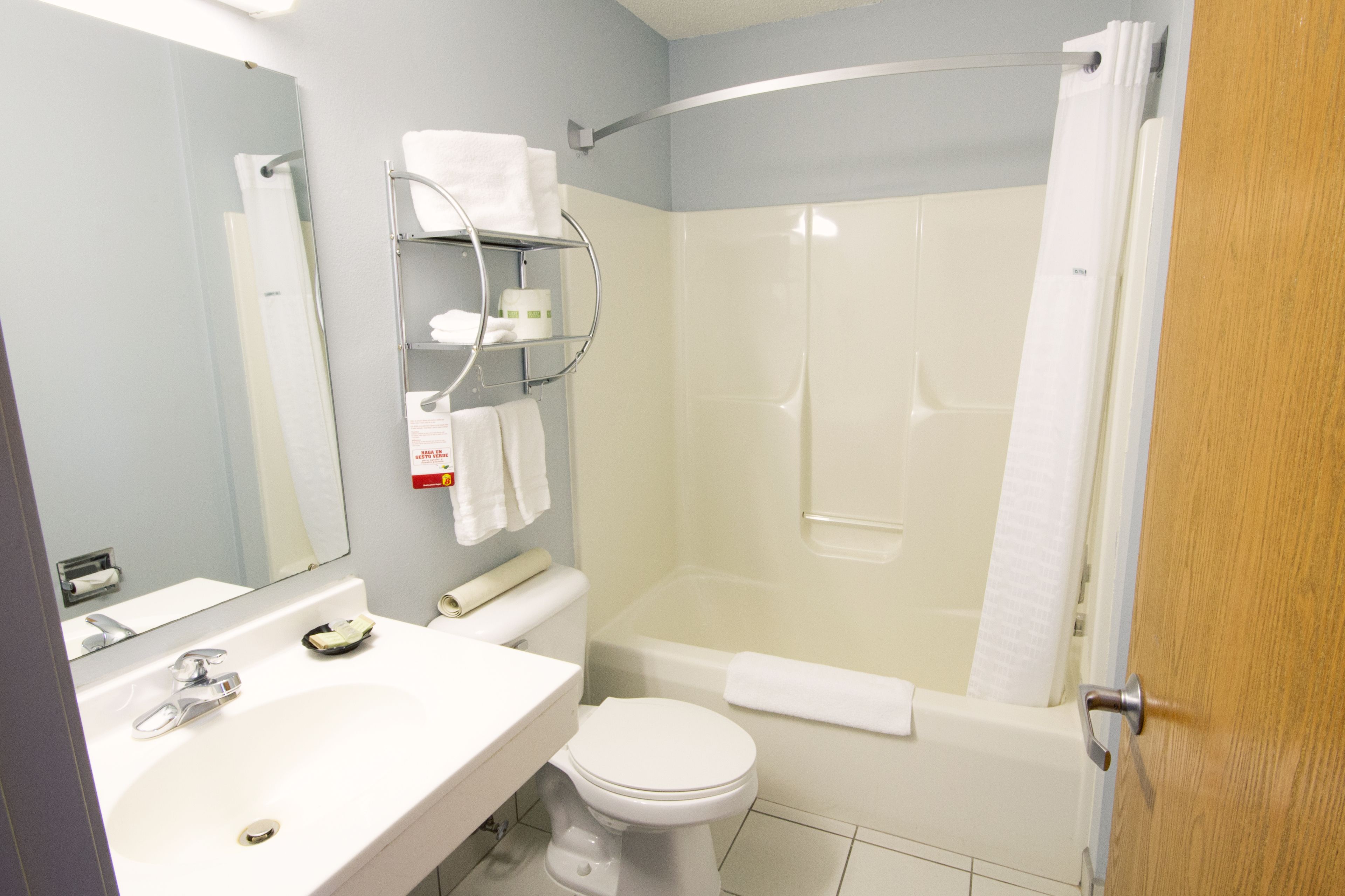 A bathroom with a sink, toilet, and shower area.