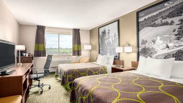 A hotel room with two beds, a desk, a TV, and a large window.