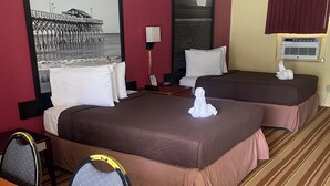 A hotel room with two beds, a dining table, and a view of the ocean. - Royal Palace Inn & Suites (Myrtle Beach)