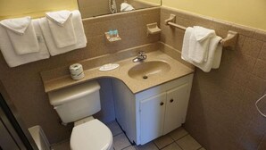 A small bathroom with a toilet, sink, and towel rack. - Royal Palace Inn & Suites (Myrtle Beach)