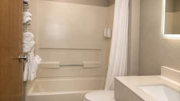 A bathroom with a bathtub, toilet, and sink.