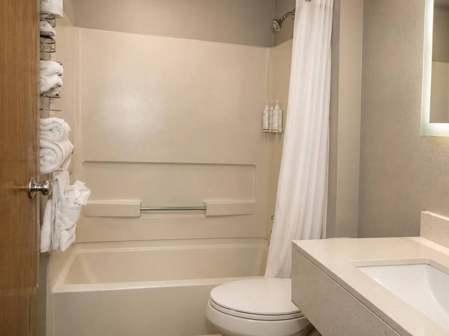 A bathroom with a bathtub, toilet, and sink.