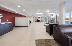 A hotel lobby with a reception desk, seating area, and a view of the outside. - Red Roof Inn Dayton - Moraine/U of Dayton (Moraine)