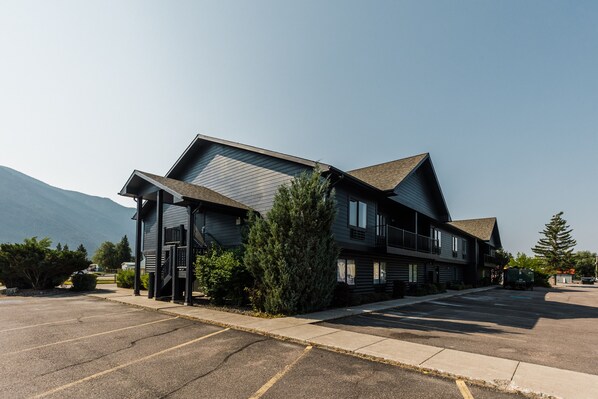 Stunning mountain views surround this two-story building with a gabled roof and inviting front porch.