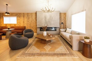 Relax in this inviting living room with a large coffee table, comfortable seating, and a fireplace.