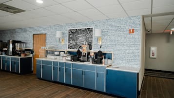 A breakfast bar with blue cabinets and a chalkboard menu.