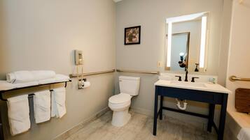 A bathroom with a toilet, sink, and towel rack.