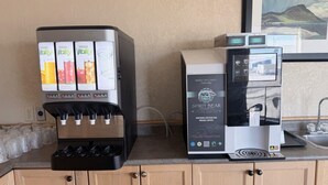 A coffee machine and a water dispenser on a kitchen counter.