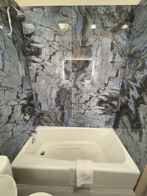 Bathtub, hair dryer, towels, soap