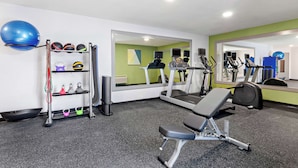 A gym with treadmills, a bench, and various exercise equipment. - Spark by Hilton Winston-Salem University (Winston-Salem)
