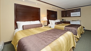 A hotel room with two beds, a kitchenette, and a microwave. - Siding 16 Lodge (Wetaskiwin)