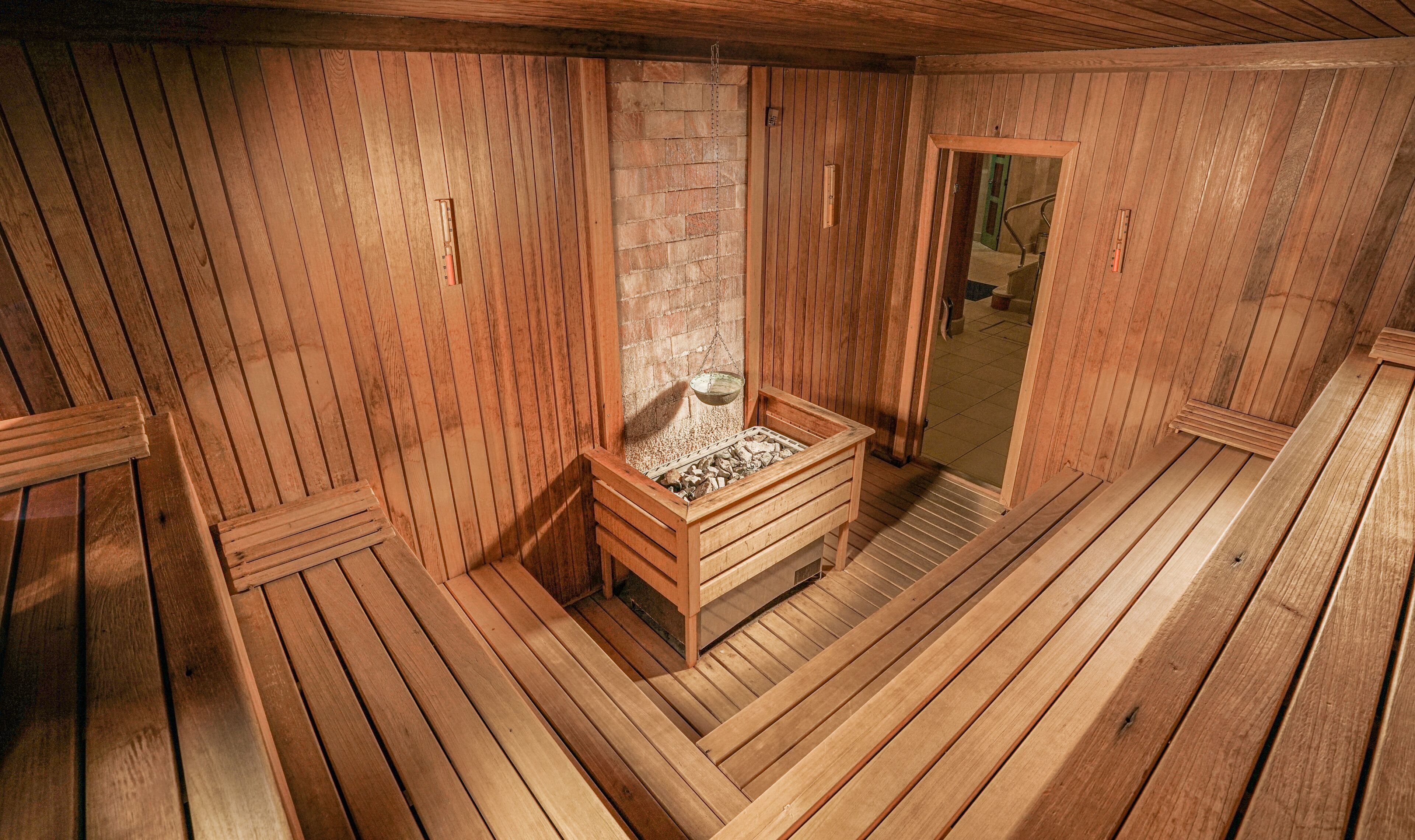 A sauna room with wooden walls and benches.