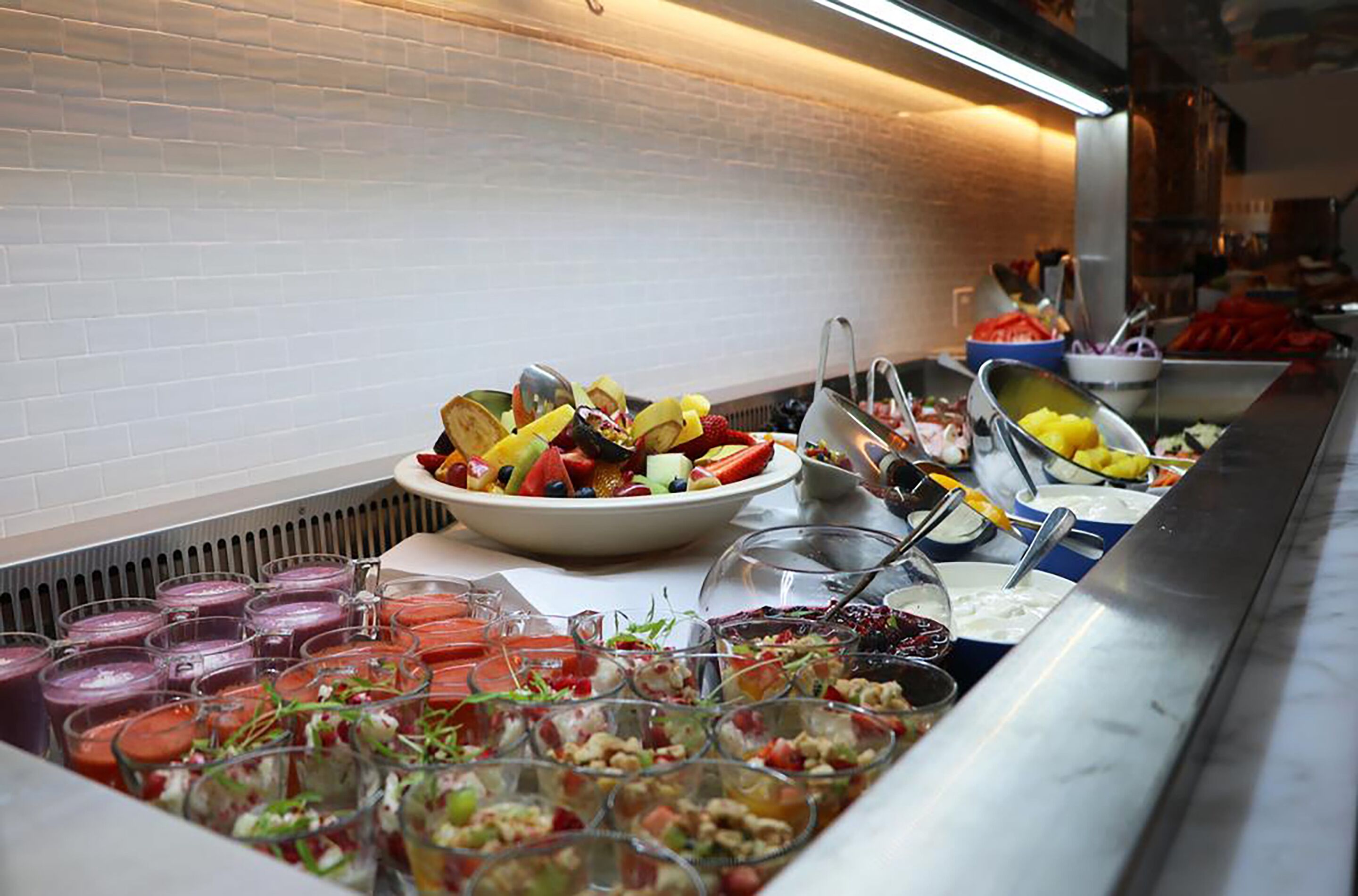 A buffet with various food items and beverages.