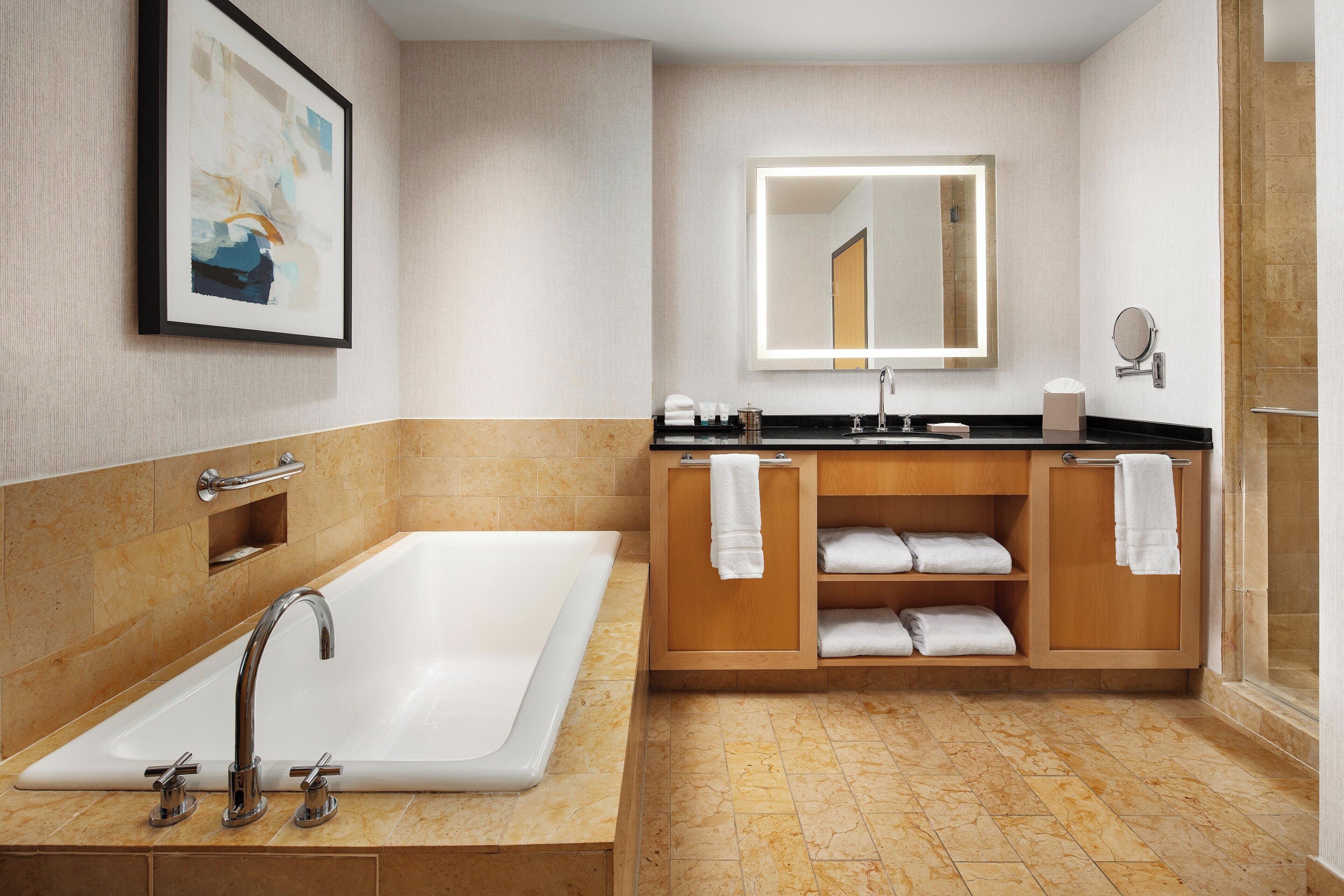 junior suite, 1 king bed with sofa bed | bathroom | separate bathtub and shower, deep-soaking bathtub, designer toiletries