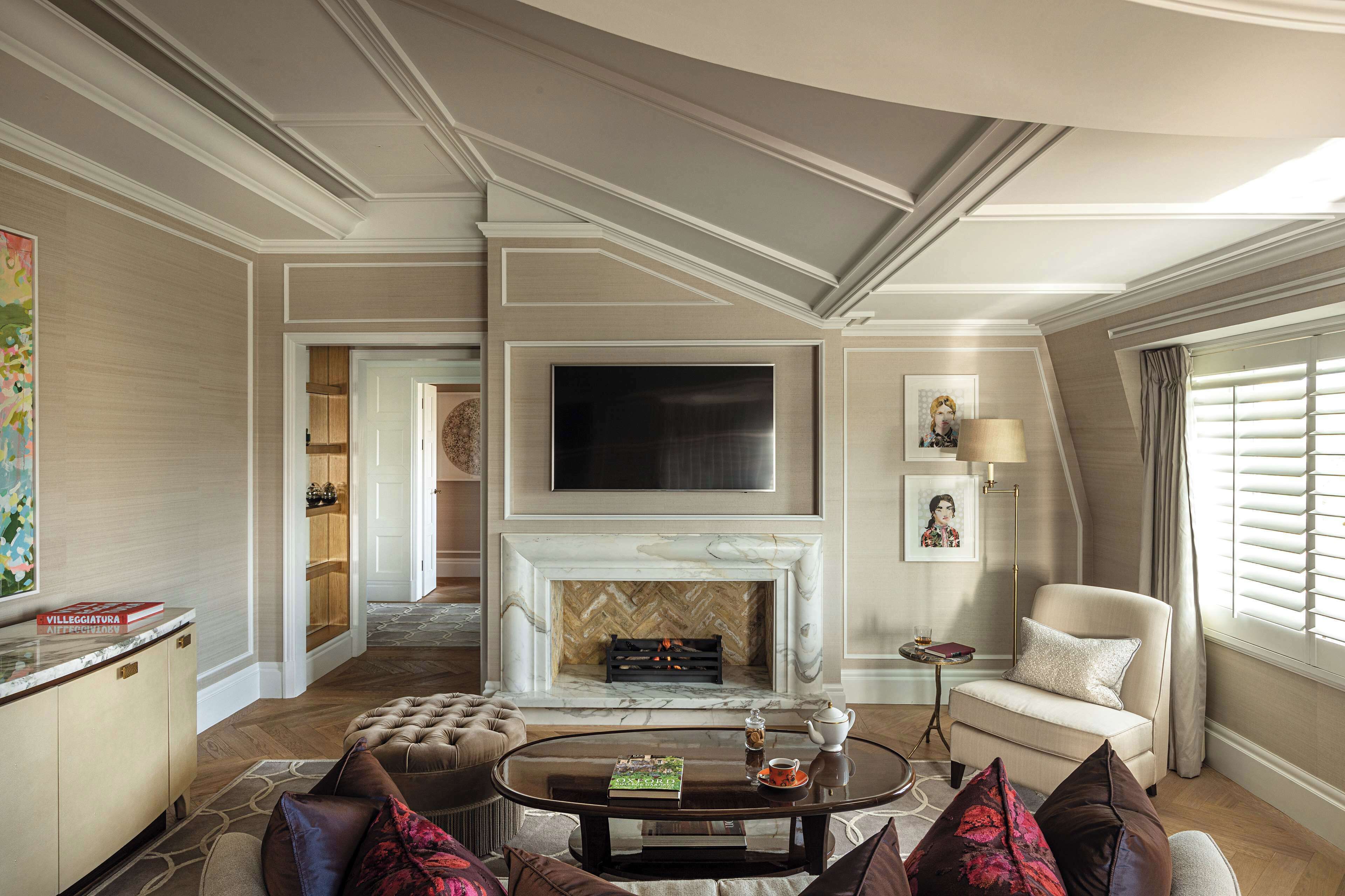 Una sala de estar con chimenea, televisor, sofá, mesa de centro y una lámpara.
