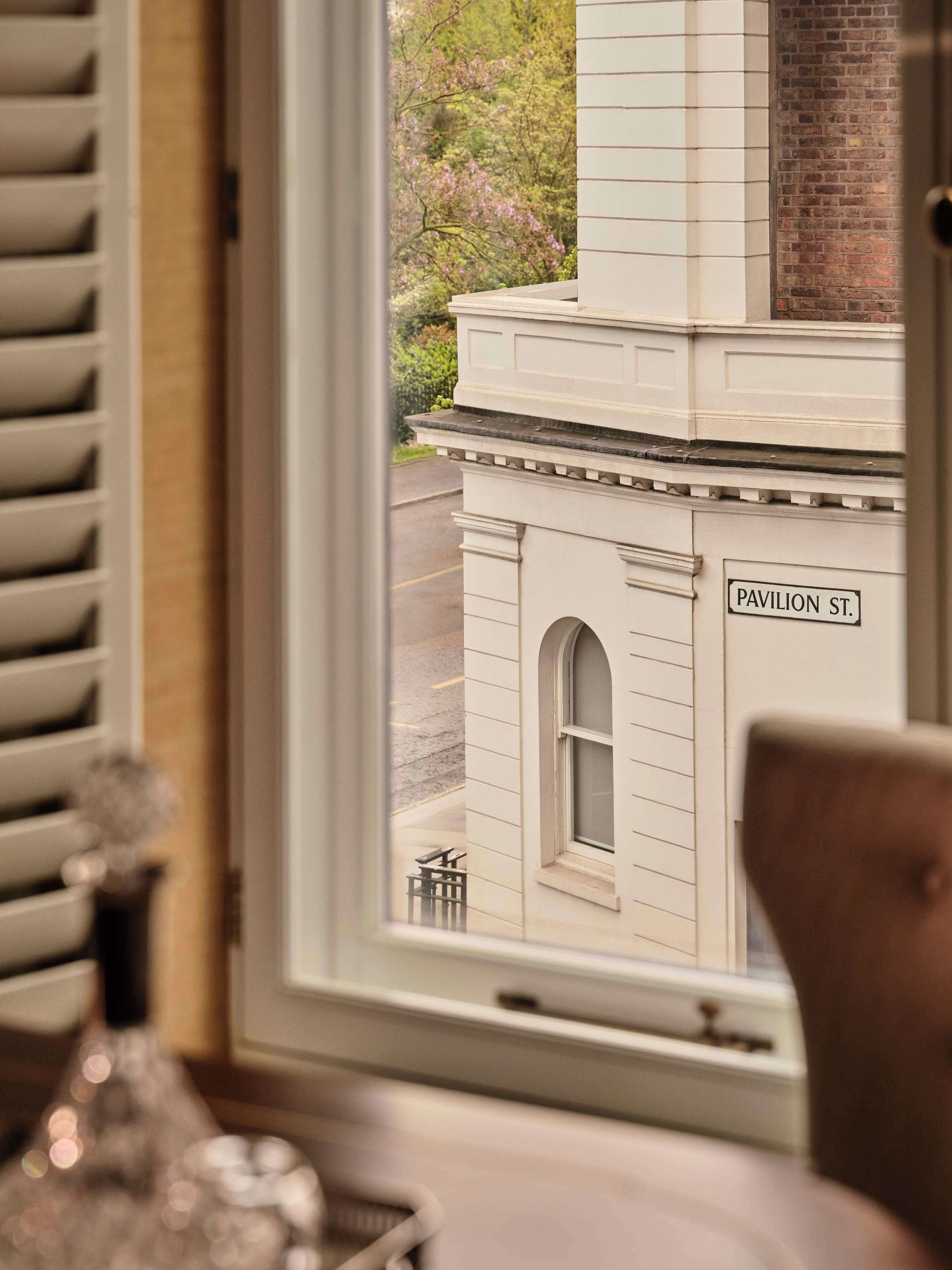 A view through a window of a building with a sign reading "PAVILION ST."