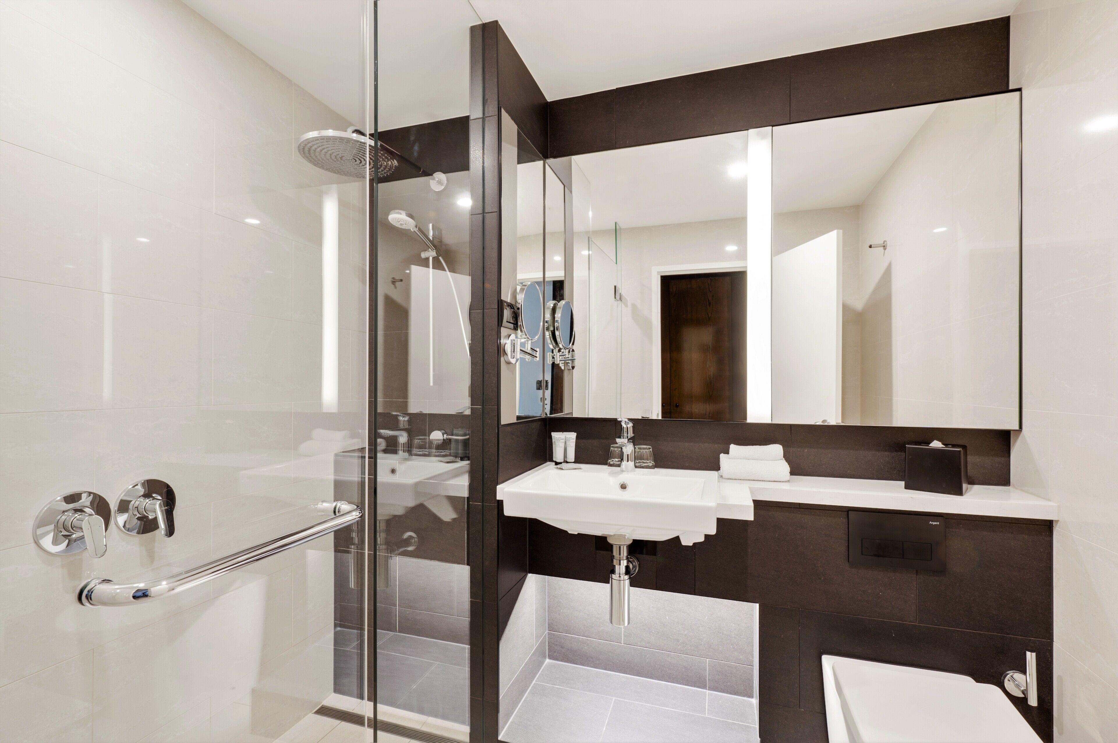 designer toiletries, hair dryer, slippers, towels