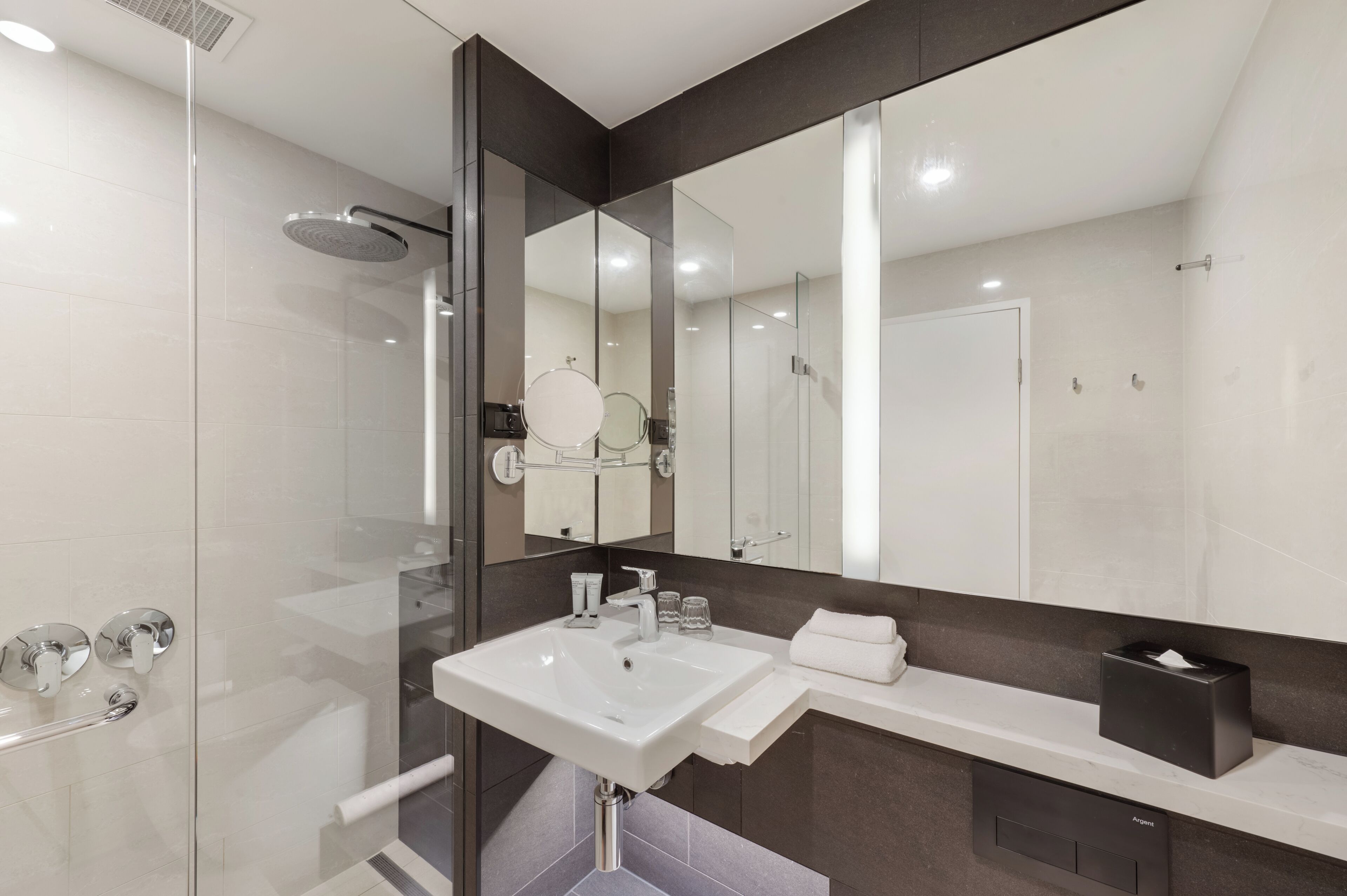 designer toiletries, hair dryer, slippers, towels