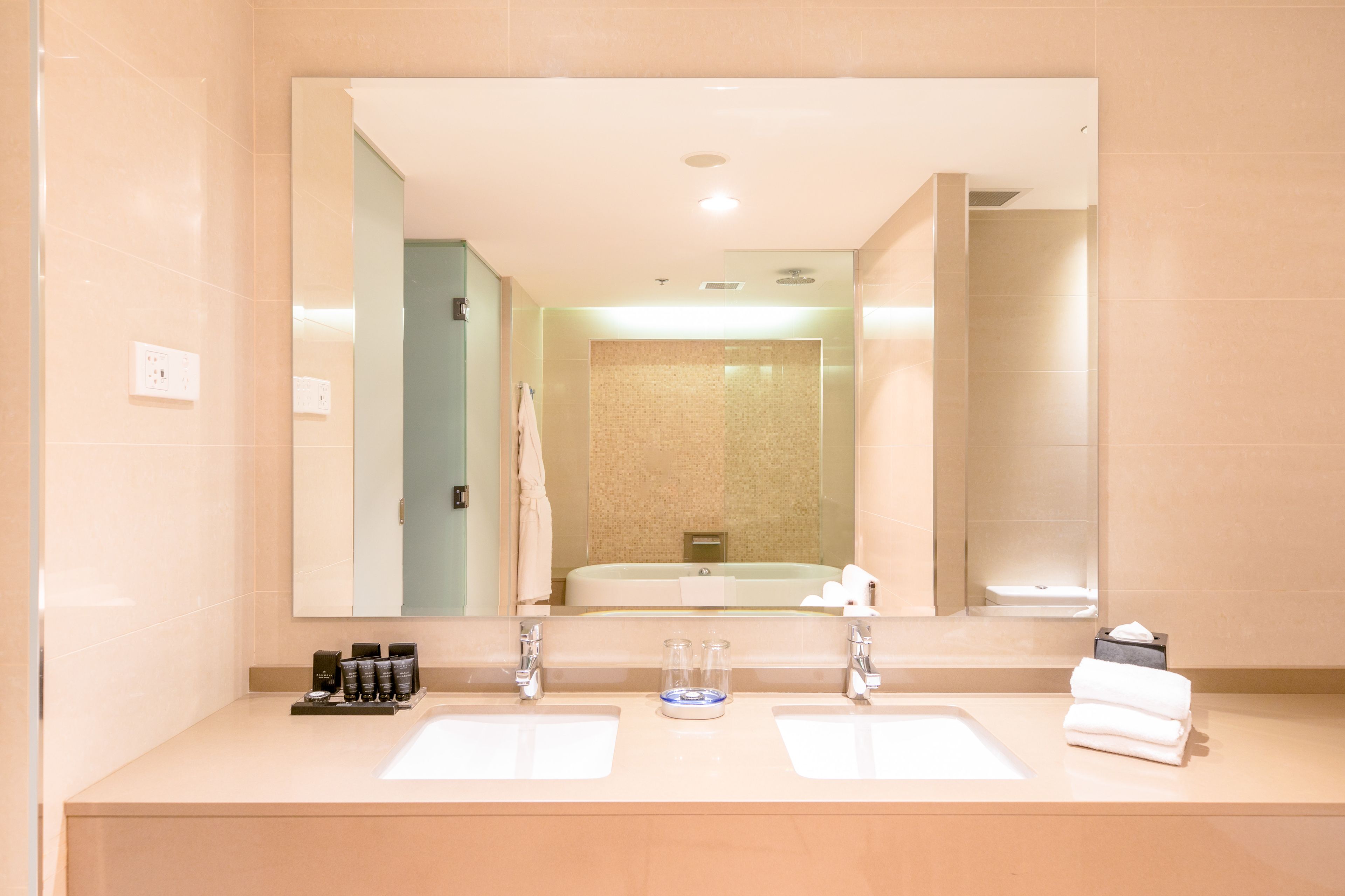 designer toiletries, hair dryer, slippers, towels