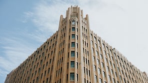 A tall, rectangular building with a symmetrical facade and numerous windows. - The Grace Hotel (Sydney)