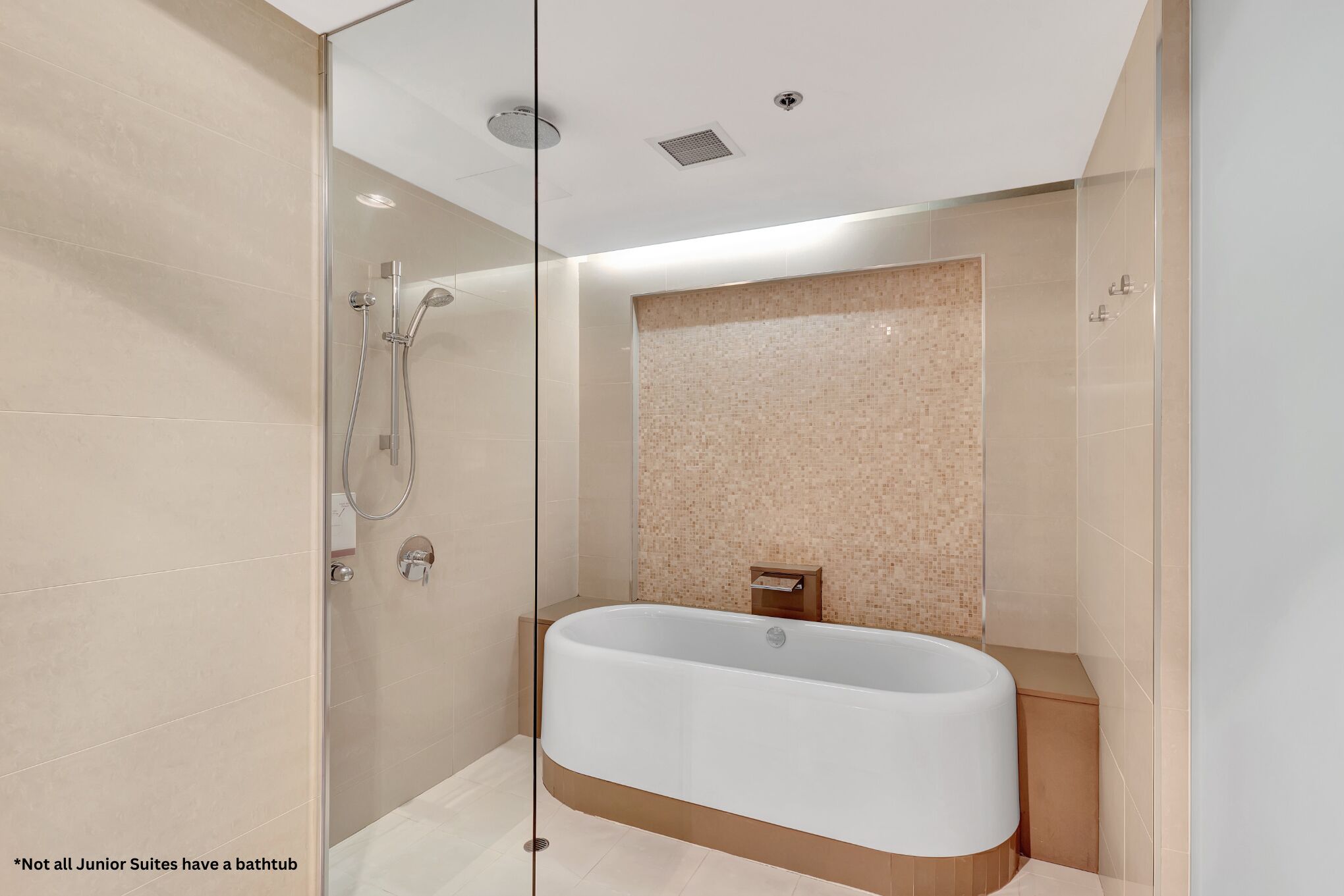 A modern bathroom with a freestanding bathtub, a glass-enclosed shower, and a tiled wall.