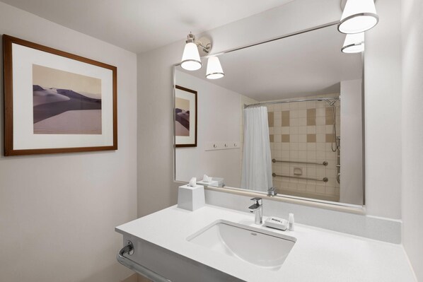 A modern bathroom with a large mirror, a sink, and a shower. - Lakeview Signature, Trademark Collection by Wyndham (Winnipeg)
