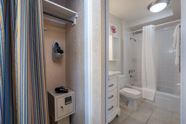 A bathroom with a shower, toilet, and sink.