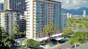 A multi-story hotel with balconies, a swimming pool, and a view of mountains. - Aqua Aloha Surf Waikiki (Honolulu)