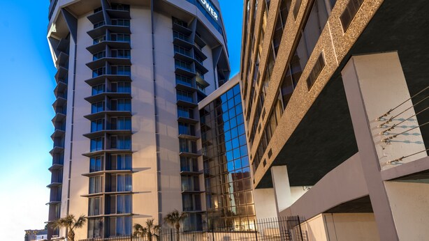 A hotel named 'COPELAND TOWER' with a modern architectural design, featuring multiple balconies and large windows.