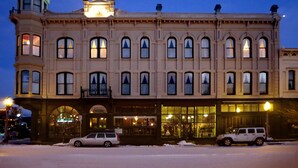 A historic building with a clock tower, large windows, and a ground-floor shop. - Geiser Grand Hotel (Baker City)