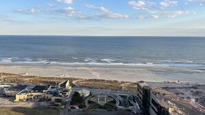 An aerial view of a coastal area with a beach, a parking lot, and a building with a central circular plaza. - The Claridge Hotel (Atlantic City)