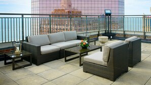 A rooftop terrace with a sofa, chairs, and a table. - The Claridge Hotel (Atlantic City)