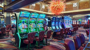 Experience the excitement of the casino floor, where slot machines line the carpeted floor and offer a variety of games.