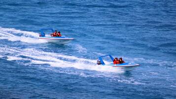Two speedboats on a body of water.