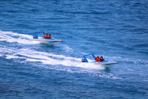 Two speedboats on a body of water.