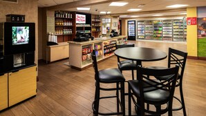 A restaurant with a bar area, a television, and a seating area with chairs. - Silver Sevens Hotel and Casino, a Wyndham Garden (Las Vegas)