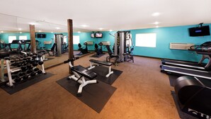 A gym with various exercise equipment, including treadmills, weight machines, and dumbbells. - Silver Sevens Hotel and Casino, a Wyndham Garden (Las Vegas)