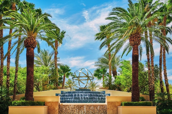 A water feature with cascading steps surrounded by palm trees. - Four Seasons Hotel Las Vegas (Las Vegas)