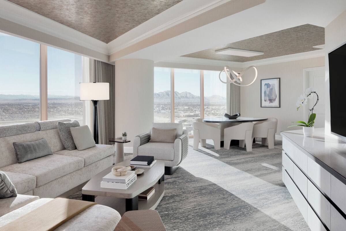 Una sala de estar moderna con sofá, mesa de centro y zona de comedor con mesa y sillas. Un ventanal grande ofrece vistas a la ciudad y a las montañas.
