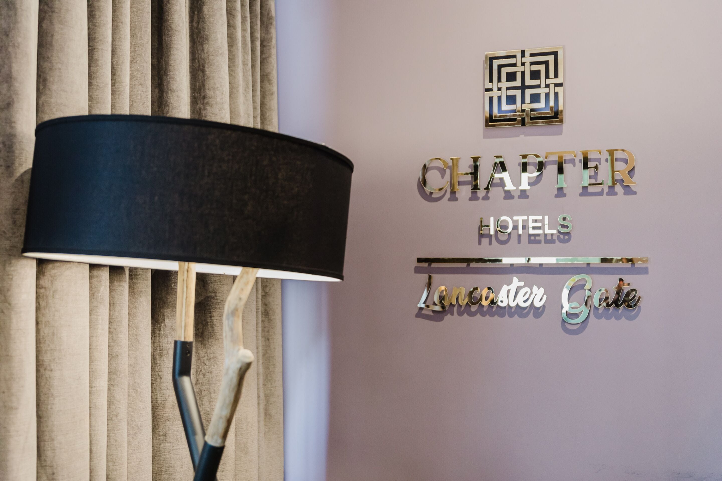 Paret amb un rètol que diu 'CHAPTER HOTELS Lancaster Gate'.